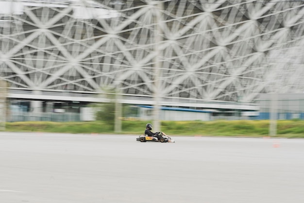 A racer pilot driving a karting car machine auto competition