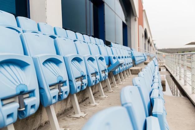 Photo racing, motosports, extreme and motoring concept - rows with folded seats of bleachers on stadium