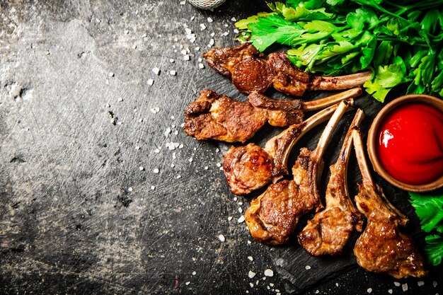 Rack of lamb with tomato sauce and parsley on the table