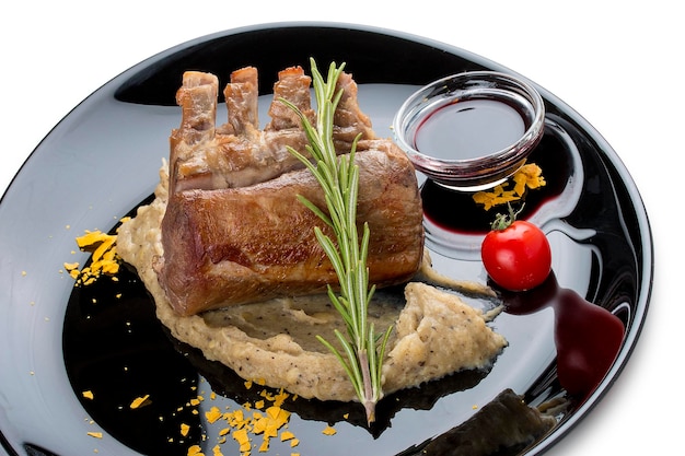 Rack of lamb with truffle puree on a black gloss plate