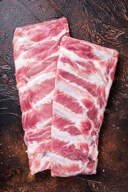 Rack of raw pork spare ribs on butcher table