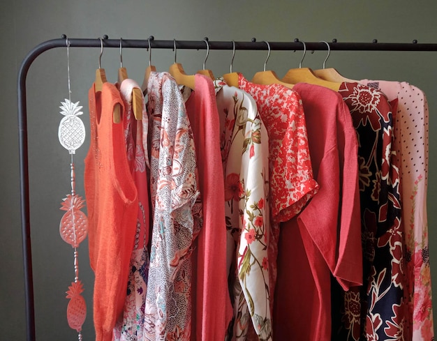 A rack of red scarfs and a pineapple on a hanger.