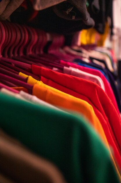 A rack of shirts with one of them hanging on the rack