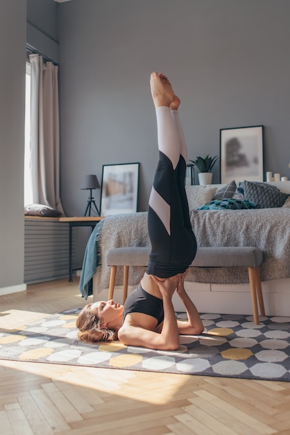 Rack on the shoulder blades. Fit woman exercising at home.