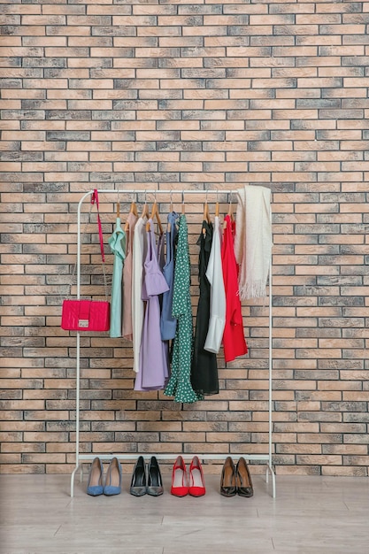 Rack with collection of clothes in dressing room