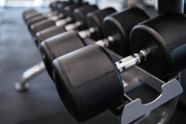 Rack with many dumbbells at gym