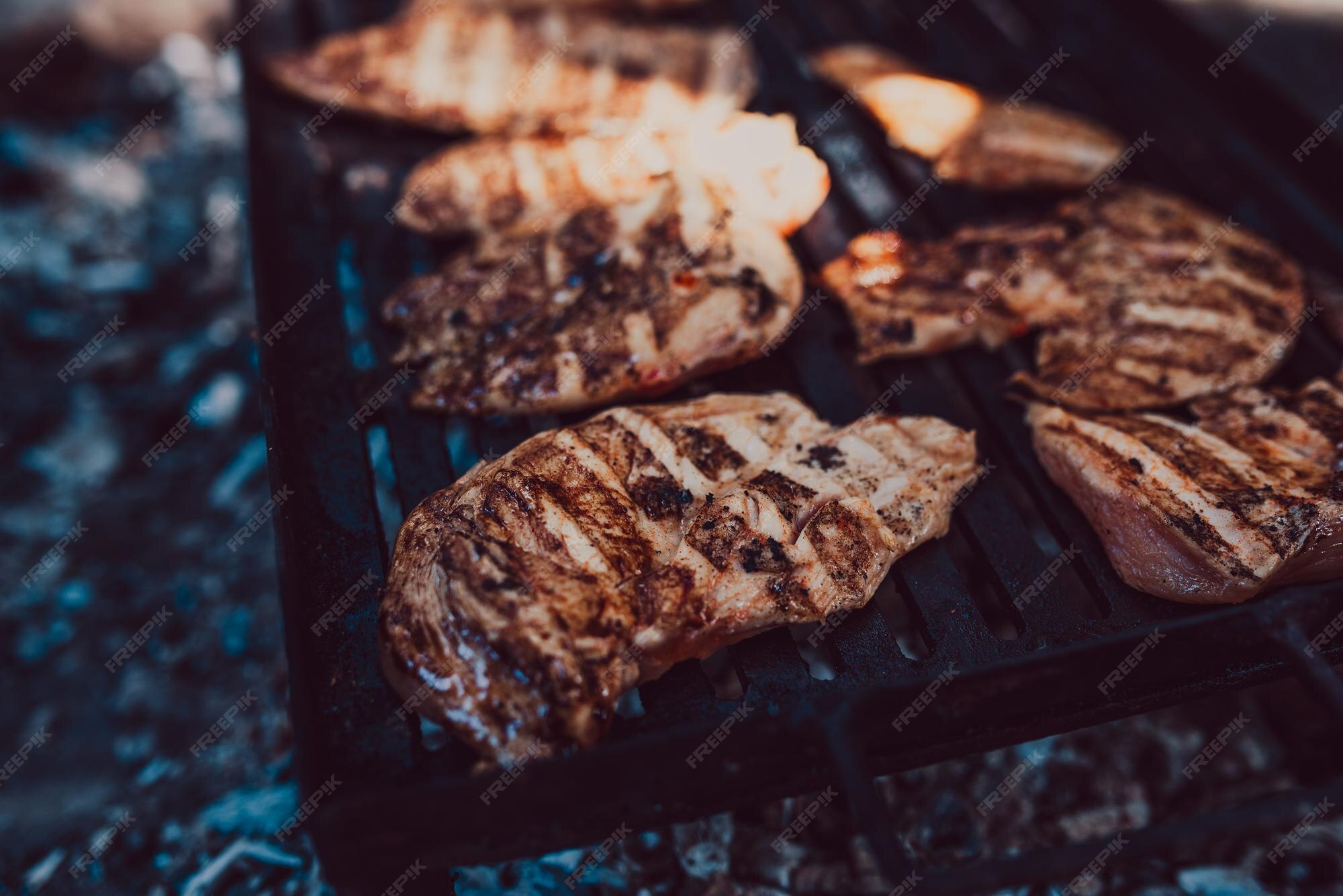 Premium Photo Racks of pork bbq ribs sitting on smoker grill with