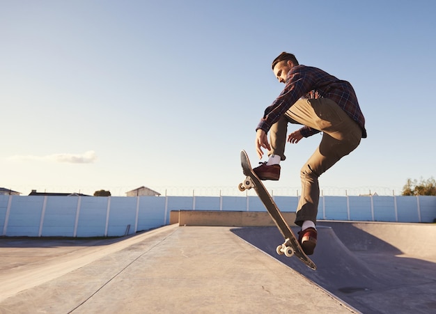 A rad day at the skate park A young man doing tricks on his skateboard at the skate park