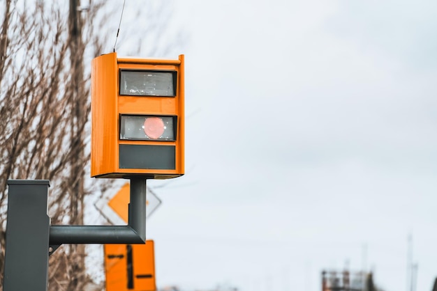 Photo a radarequipped speed camera monitors the traffic on a road flashing a yellow light when it catches a car exceeding the speed limit and using technology to identify the vehicle and enforce the law