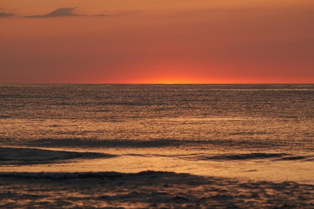 Radiant Sunset Over the Ocean The Glowing Sun Sinking on the Horizon