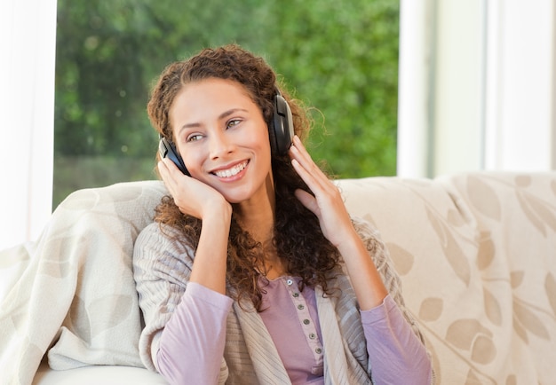 Radiant woman listening to music