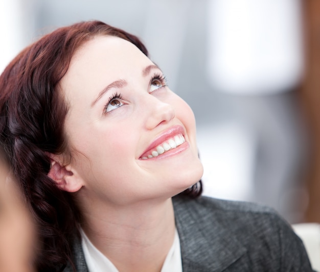 Radiant young buinesswoman smiling in a meeting 