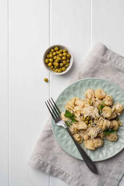 Radiatori pasta with cherry tomatoes cheese and parsley in white plate on wooden background