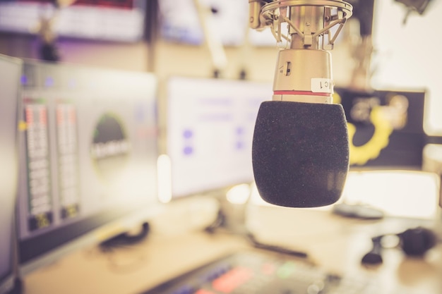 Radio broadcasting studio Microphone in the foreground modern studio in the blurry background