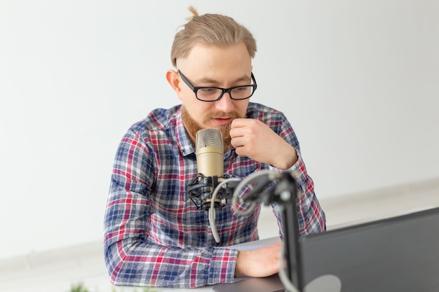 Radio host concept - Close-up of handsome man working as radio host at radio station