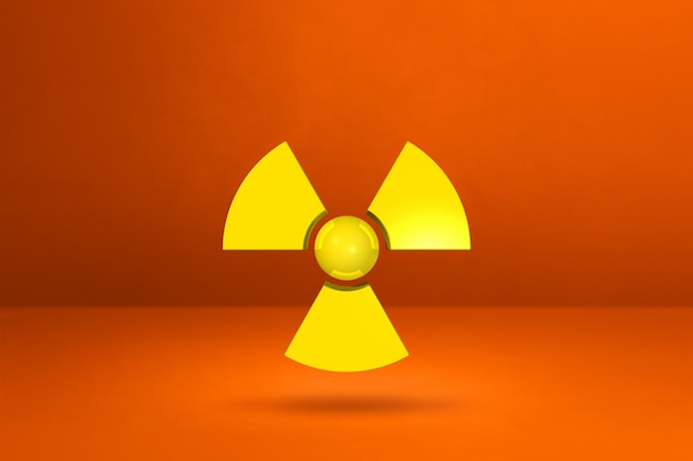 Photo radioactive symbol isolated on a orange studio