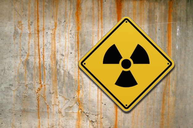 Photo radioactive warning sign on a wall