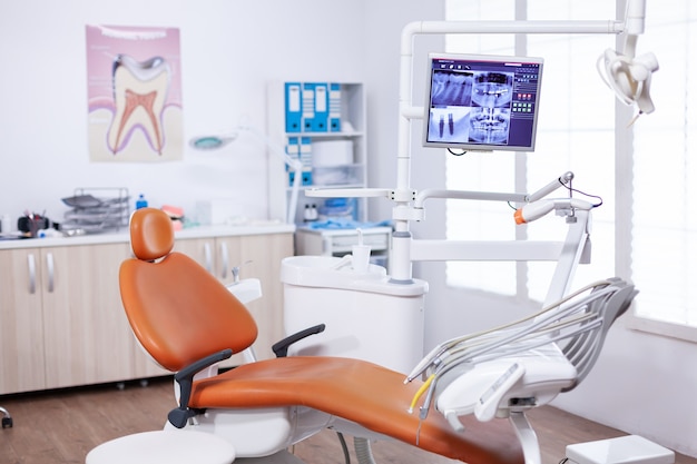 Radiography of patient jaw on screen display in dentist office. Stomatology equipment in dental private hospital with nobody in it. Different dental instruments and tools.