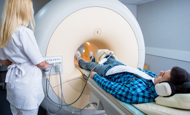 Radiologist prepares the patient for an MRI knee examination