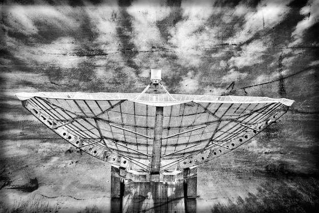 Radiotelescope focus to the sky in grunge style