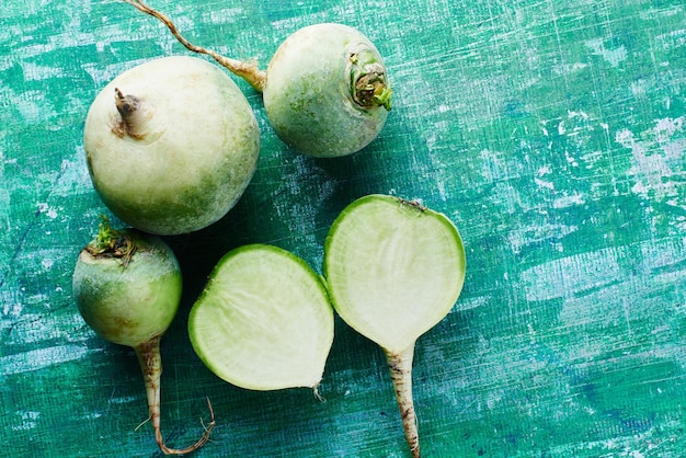 Radish on a green shabby background. Top view.