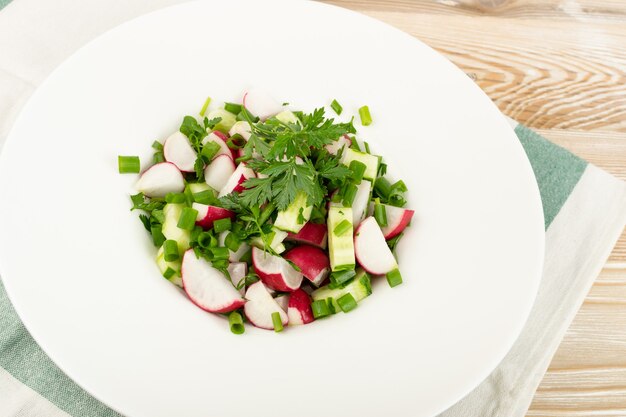 Radish salad on white restaurant plate close up