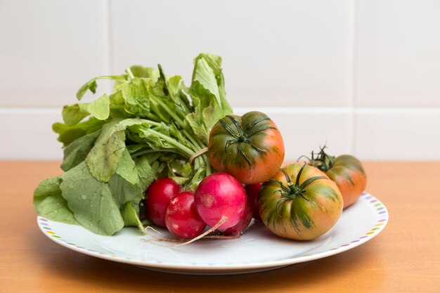 Radishes and tomatoes on a plate