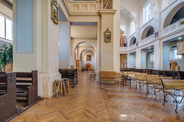 RADUN BELARUS MAY 2021 interior of old baroque catholic church with frescoes icons paintings Columns ceiling and vaulting