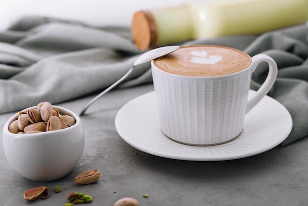 Raf coffee in cup and pistachios in bowl