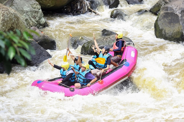 Rafting on a mountain river Group of mixed tourist guided by a professional pilot on the river