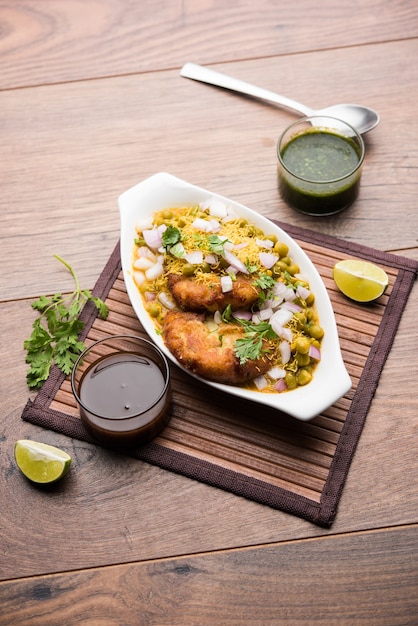 Ragda Pattice is a popular Street food or chat made of potato Patties. served in a steel plate, bowl or ceramic plate with tamarind and cilantro chutney