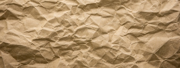 Ragged crumpled brown kraft paper texture banner background