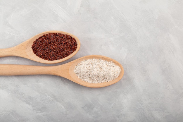 Ragi or Nachni also known as finger millet and ragi coarse flour in wooden spoons closeup