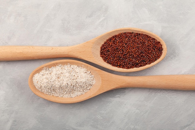 Ragi or Nachni and Organic ragi coarse flour in wooden spoons on grey background top view