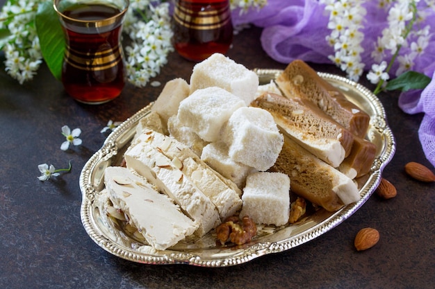 Rahat Lukum, sherbet, halva and tea on the kitchen table. Turkish and Arabic sweets. Ramadan food.