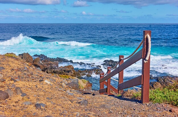 Railed footpath on the coast of Tenerife by the sea, The Canaries, Spain. Landscape, seascape