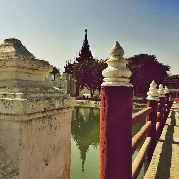 Railing by pond in temple on sunny day