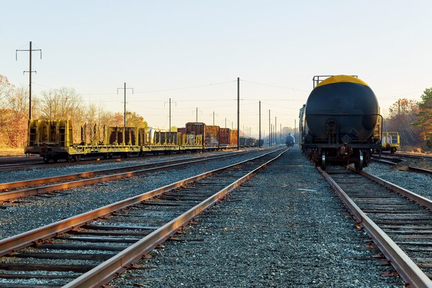 Railroad in autumn going to the city with colorful trees in colors by the tracks in the fall