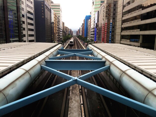 Railroad station amidst buildings in city