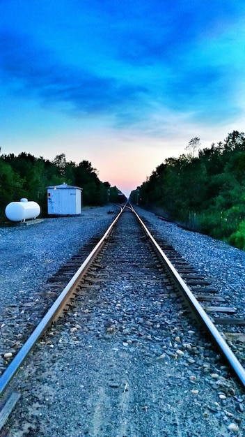 Railroad track against cloudy sky