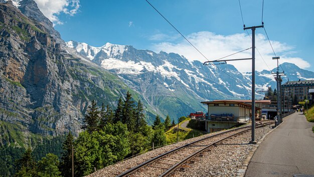 Railroad track amidst mountains against sky