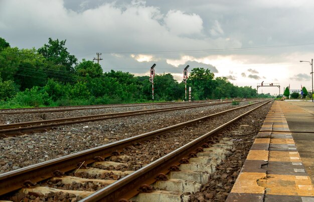 Railroad tracks amidst trees against sky