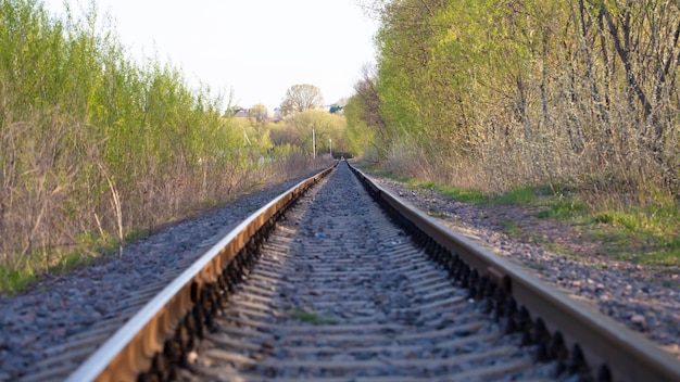 The railroad tracks of the old railway go into the distance