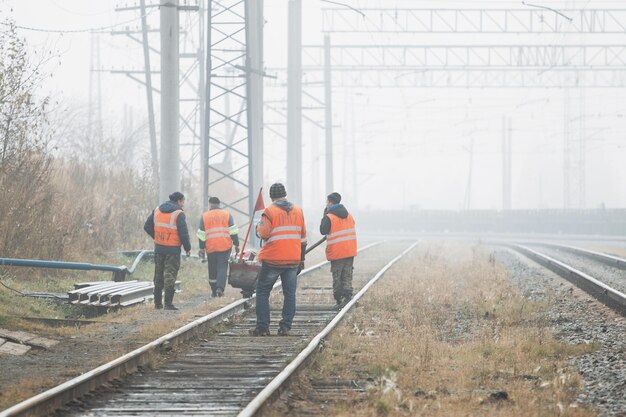 Photo railroad workers maintaing railways checking construction