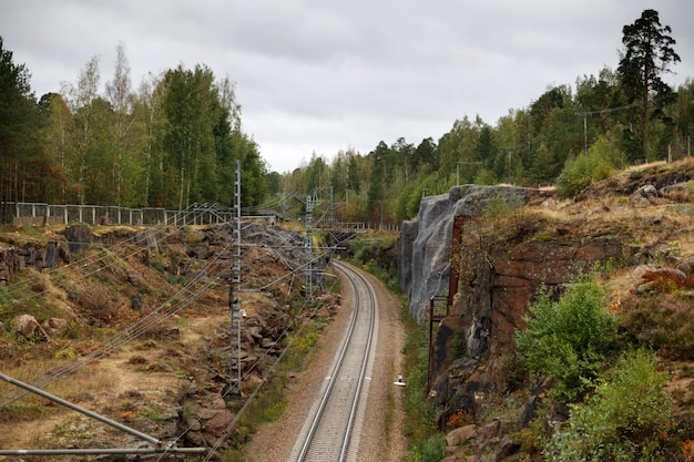 Railway among mountains. Autumn season, cloudy weather.