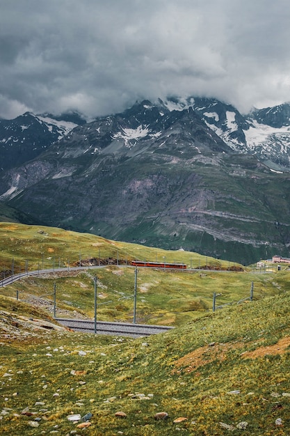Railway in mountains and red train Zermatt Swiss Alps adventure in Switzerland