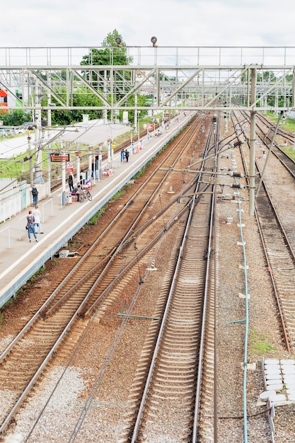 Railway platform with passengers. View from above. Vertical.