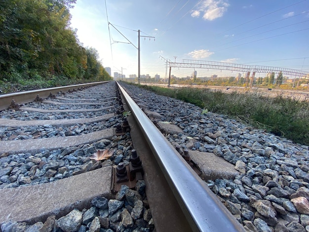 Railway rails with no train in sight under blue sky