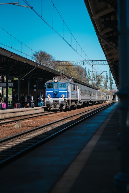 Railway track of the main station with an arriving train to Gdansk Poland