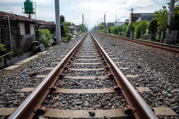 Photo railway tracks around settlements in rural areas in indonesia